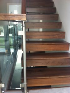 cantilevered stairs in walnut and glass