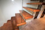 Cantilevered stairs with glass riser and balustrade